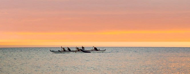 A group canoeing on the ocean