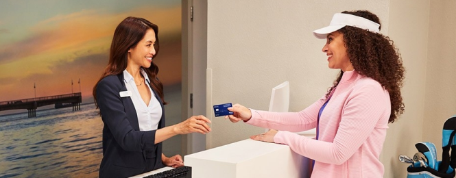 Woman paying with credit card in hotel